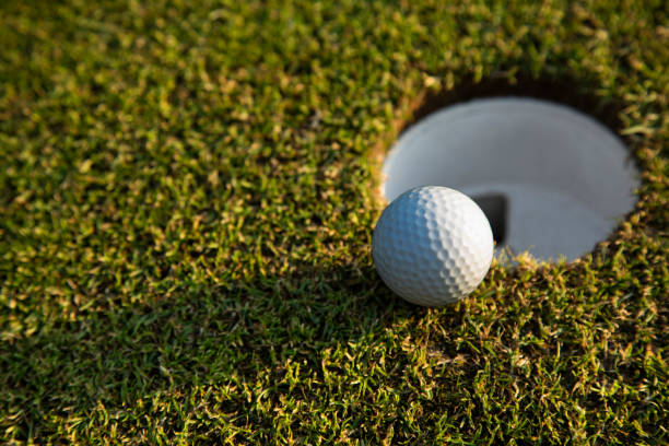 istock Closeup Golf ball on green grass on course 2165862502