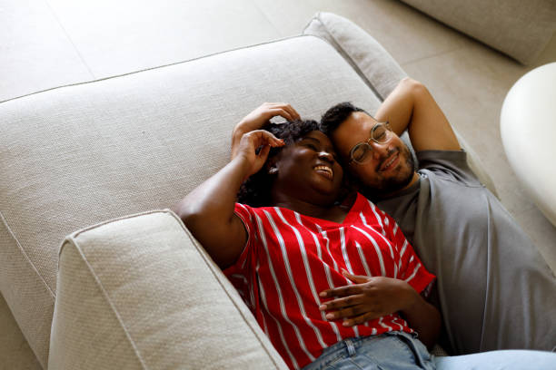 istock Couple lying down and having romantic moment on couch 2165862714