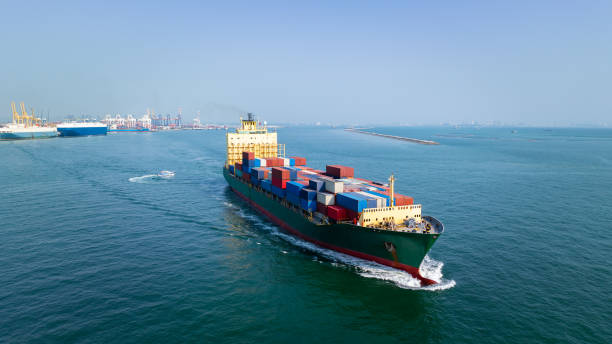 istock logistic cargo container ship sailing in sea import export goods and distributing products to dealer and consumers across worldwide, by container ship Transport business service 2165863318
