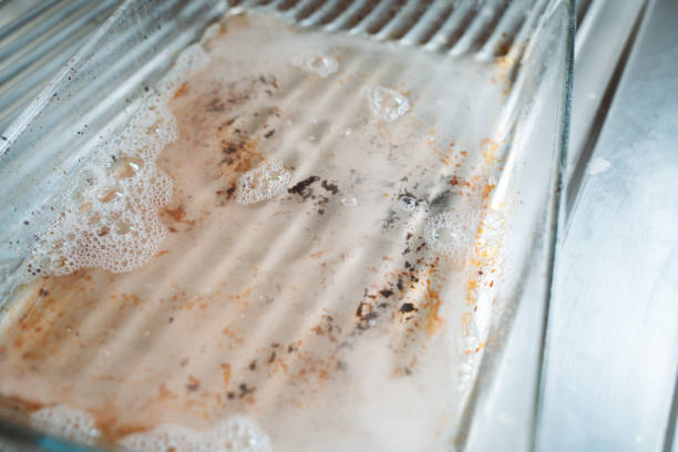istock Dirty Glass Tray Being Cleaned in Kitchen Sink 2165866866
