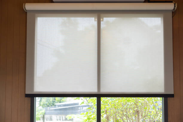 istock A white blind is drawn over a window, with a view of a tree outside 2165867094