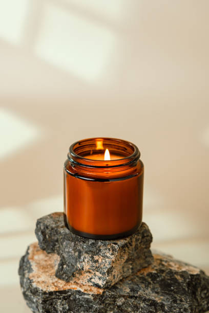 istock Glass Jar On Stacked Rocks Against Beige Background 2165869227