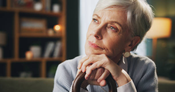 istock Walking stick, thinking and senior woman in home with memory, remember or nostalgia for past. Dreaming, medical support and elderly female person with cane for dementia disease in retirement facility 2165869331