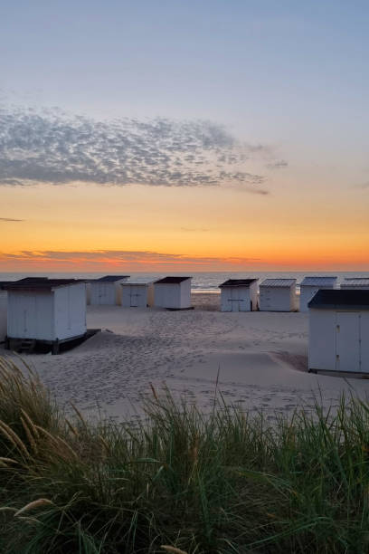 istock Tranquil Beach at Sunset with Colorful Sky and Beach Huts for Summer Vacation 2165871688