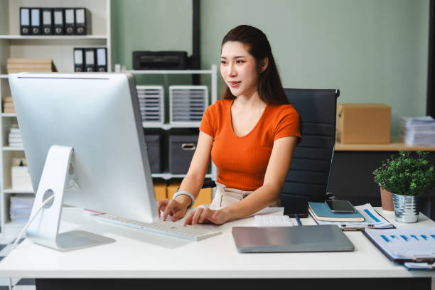 istock Business woman or financial data analysts working with smartphone and laptop computers and data graphs together. Plan to analyzing projects in the office. 2165872383