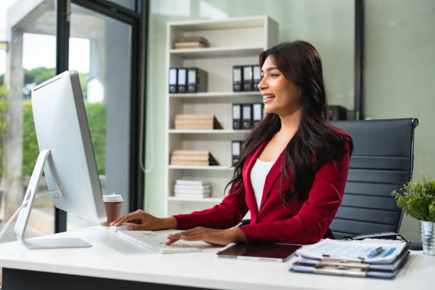 istock Business women hand working with tablet and laptop computer with documents on office desk in modern office. 2165872434
