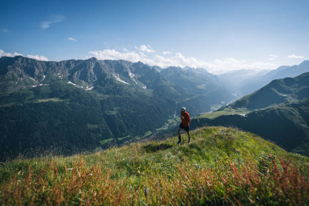 istock Trail runner bounds along mountain trail 2165872507