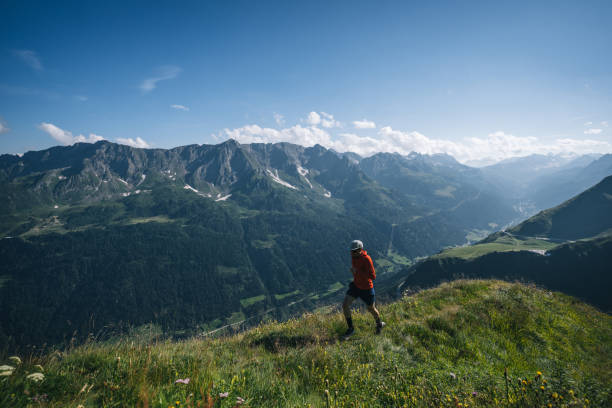 istock Trail runner bounds along mountain trail 2165872732
