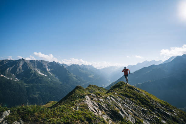 istock Trail runner bounds along mountain trail 2165873003
