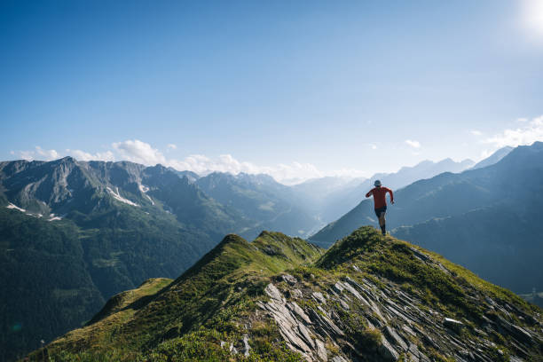 istock Trail runner bounds along mountain trail 2165873006