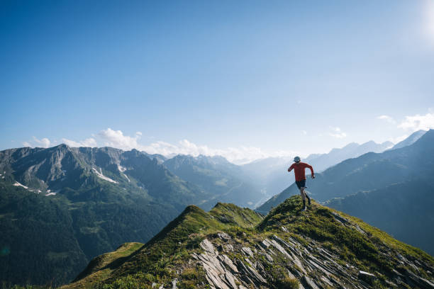 istock Trail runner bounds along mountain trail 2165873008