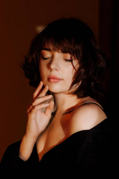 A woman with closed eyes turning away from the camera