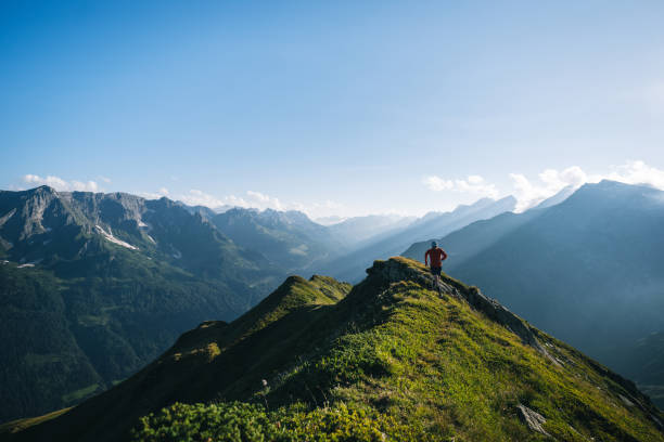 istock Trail runner bounds along mountain trail 2165873379