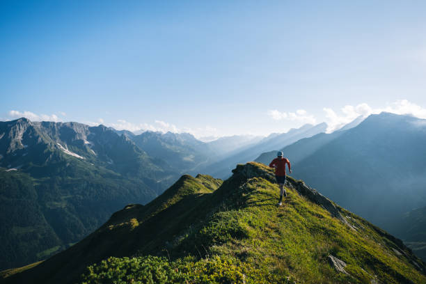 istock Trail runner bounds along mountain trail 2165873380