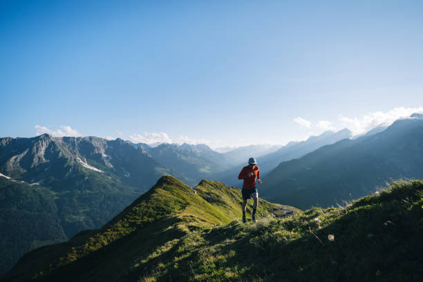 istock Trail runner bounds along mountain trail 2165873511