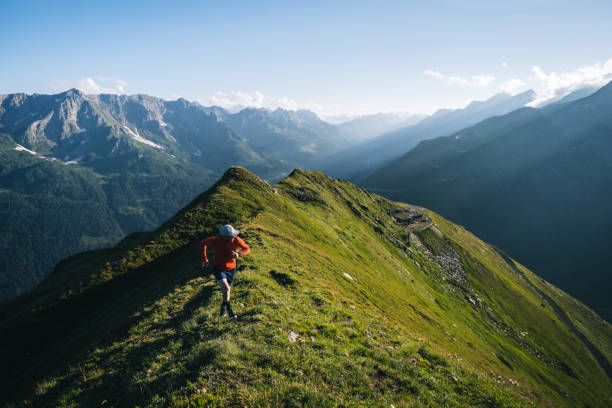 istock Trail runner bounds along mountain trail 2165874225