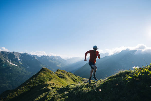 istock Trail runner bounds along mountain trail 2165874228