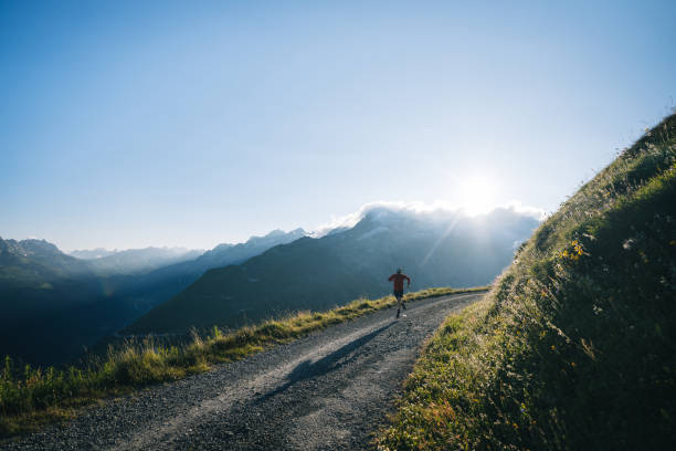 istock Trail runner bounds along mountain road 2165874528