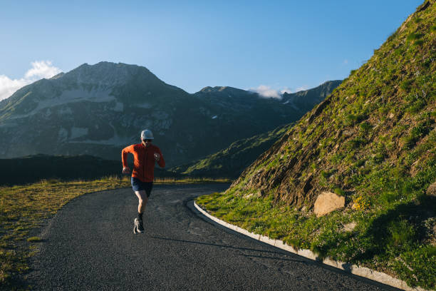 istock Trail runner bounds along mountain road 2165874855