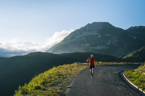 istock Trail runner bounds along mountain road 2165874860