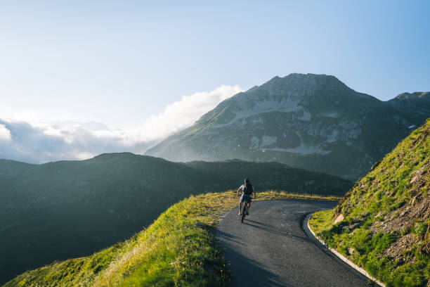 istock Mountain biker rides mountain road 2165875028