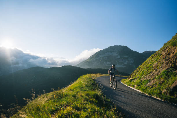 istock Mountain biker rides mountain road 2165875207