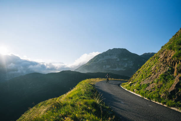 istock Mountain biker rides mountain road 2165875209