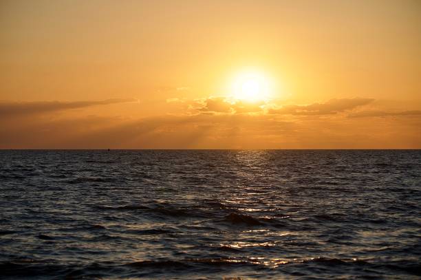 istock Sunset over the ocean orange red yellow sky 2165875256