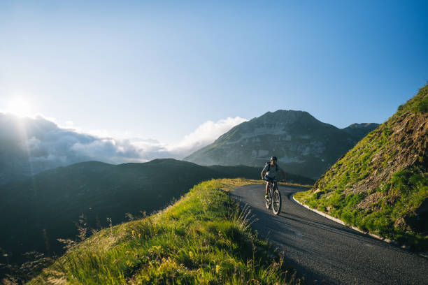 istock Mountain biker rides mountain road 2165875259