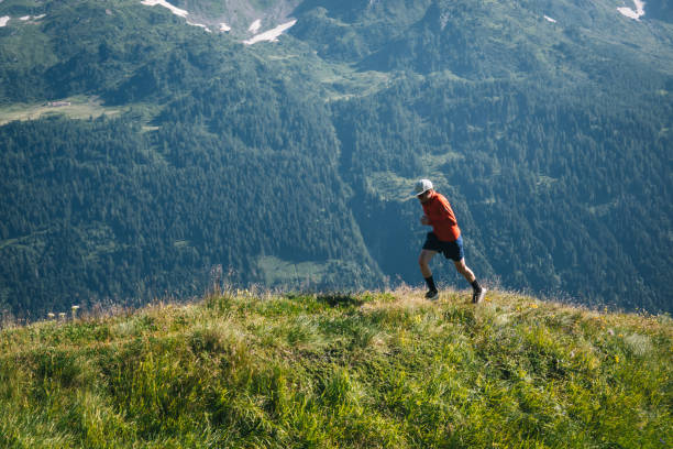 istock Trail runner bounds along mountain trail 2165875286