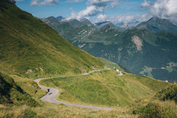istock Mountain biker rides mountain road 2165875294
