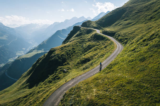 Mountain biker rides mountain road