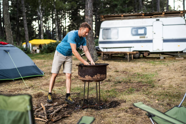 istock Young man preparing wood for campfire 2165877085