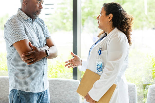 istock Mid adult female physician gestures while explaining treatment options 2165878186