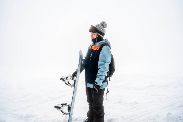 istock Woman snowboarder on a snowy mountain 2165878613