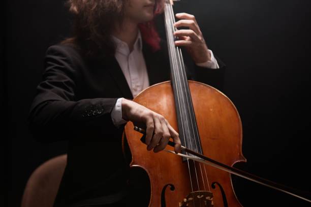 istock Cellist Performing Music with Violoncello in Black Suit 2165878994