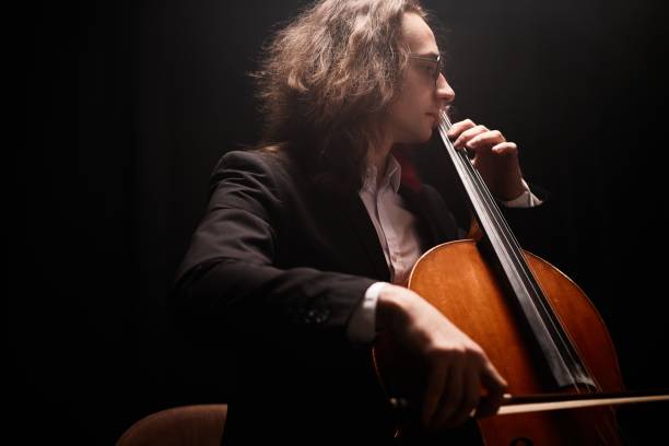 istock Young Violoncello Player in Suit Performing Symphony 2165878997
