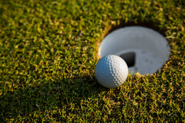 istock Closeup Golf ball on green grass on course 2165880822