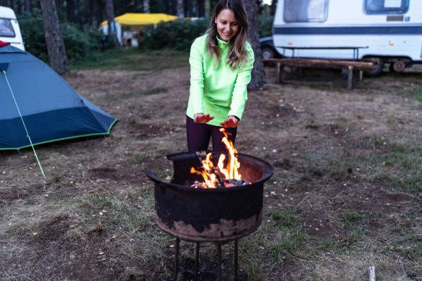 istock Woman warming her hands by the campfire 2165880995