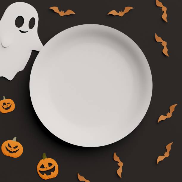 istock Halloween plastic paper dish plate with copy space and orange bats, Jack o Lantern pumpkins and ghost decor 2165881898