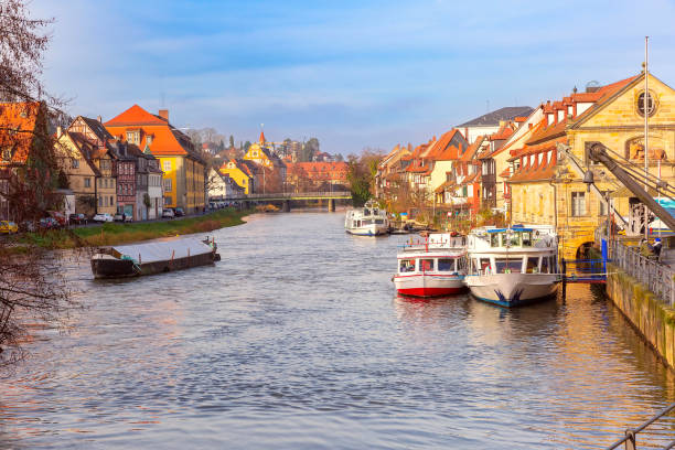 View of the picturesque Little Venice district along the Regnitz River in Bamberg, Germany, with historic half-timbered houses and boats