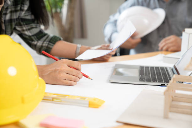 istock Architects are collaborating on a house design at the office 2165884563