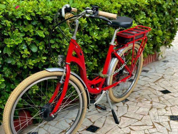 istock Red vintage bicycle parked in front of bush 2165885656