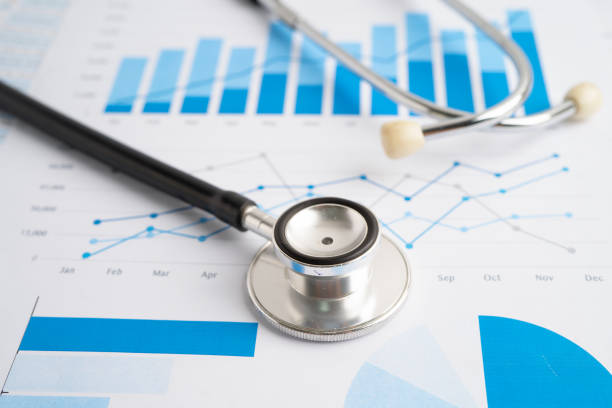 istock Stethoscope on spreadsheet and graph paper, Finance, Account, Statistics, Investment, Analytic research data economy and Business company concept. 2165885727