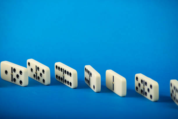 istock Dominoes standing on a blue background. 2165887620