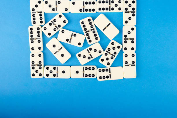 Dominoes on a blue background. White Bones Board Game.