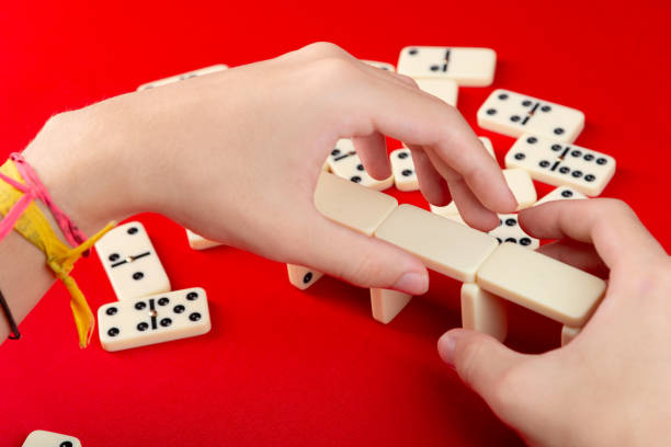 istock Male hands making assembly with dominoes. acrylic pieces. 2165887662