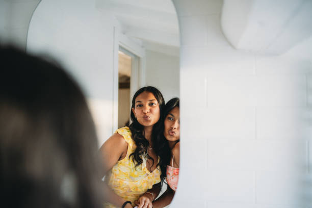 Portrait of lovely strange sad girl. Beautiful melancholic young woman sitting on stool at the mirror