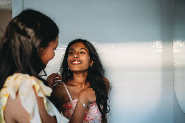 istock Two happy sisters sharing a moment and smiling in bathroom 2165889714