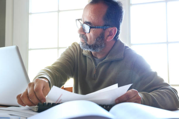 istock Hispanic Businessman Working On Computer At Home 2165890673